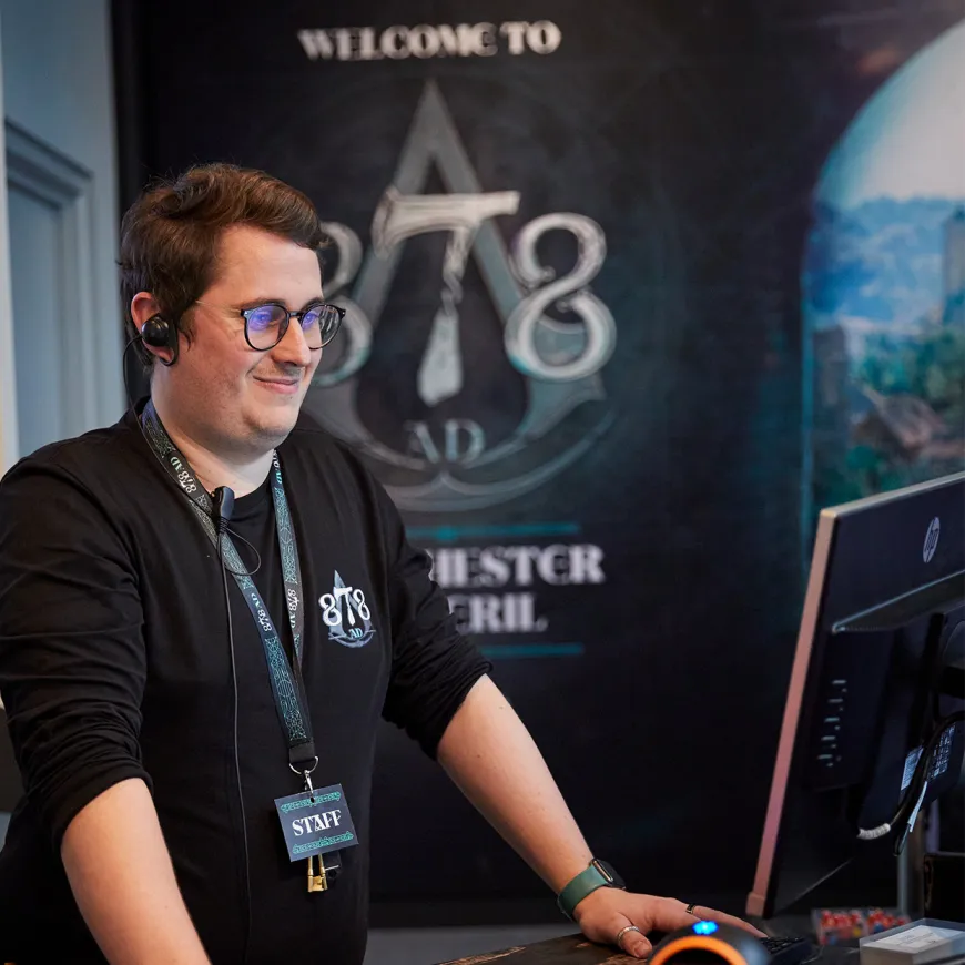 A man un 878AD uniform processes a ticket through the desk computer