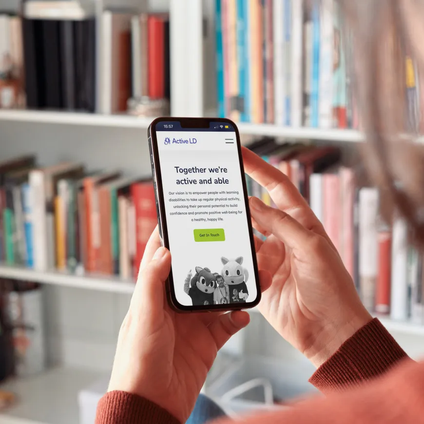 Woman holding mobile phone with Active LD homepage