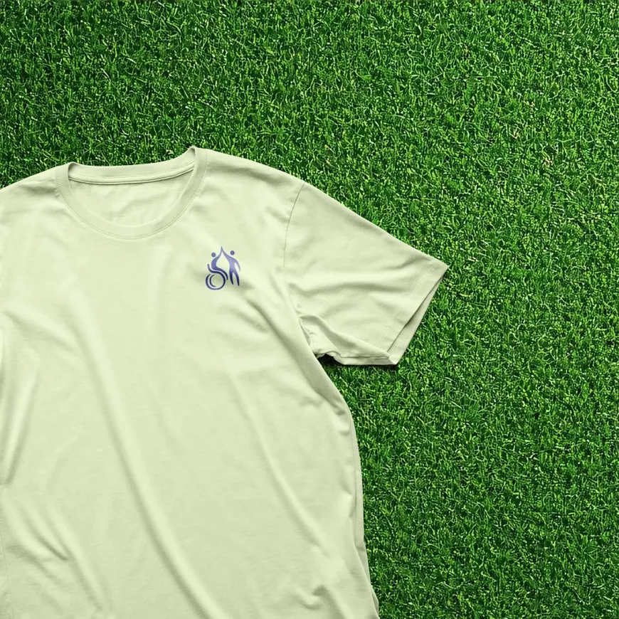Green t-shirt laid out on astro turf fake grass