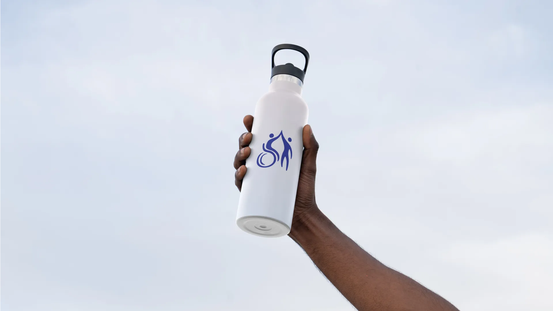 Hand holding Active LD branded water bottle in the sky