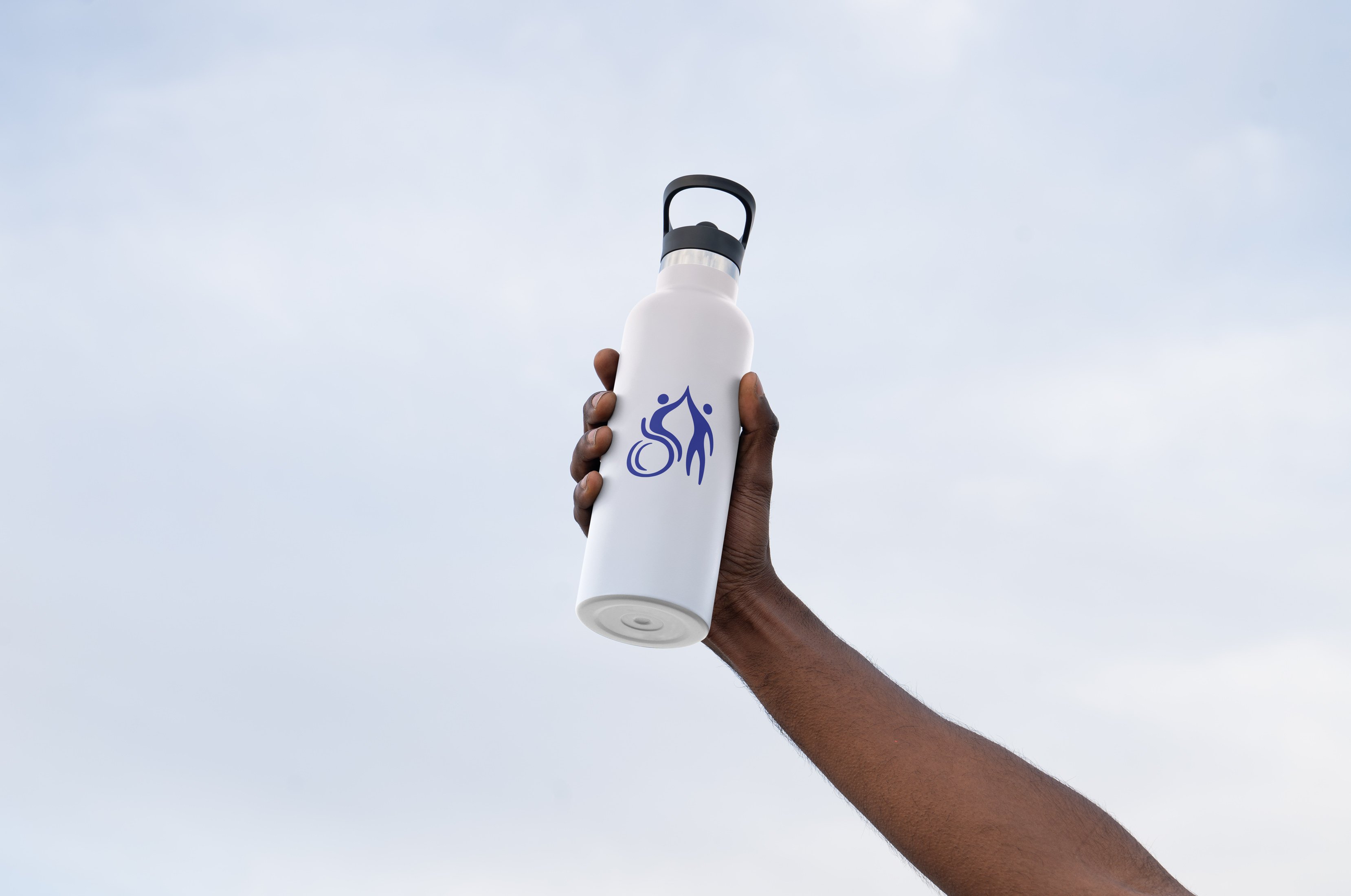 Hand holding Active LD branded water bottle in the sky