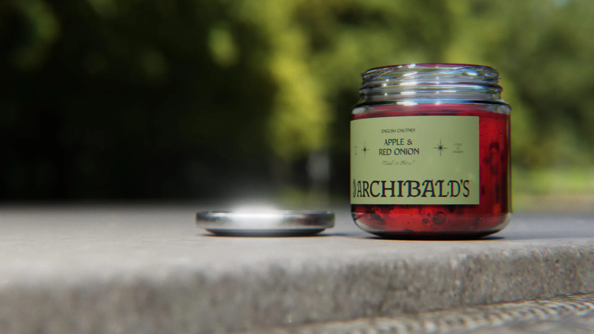 Glass jar of Archibald’s apple and red onion chutney open outside on wall