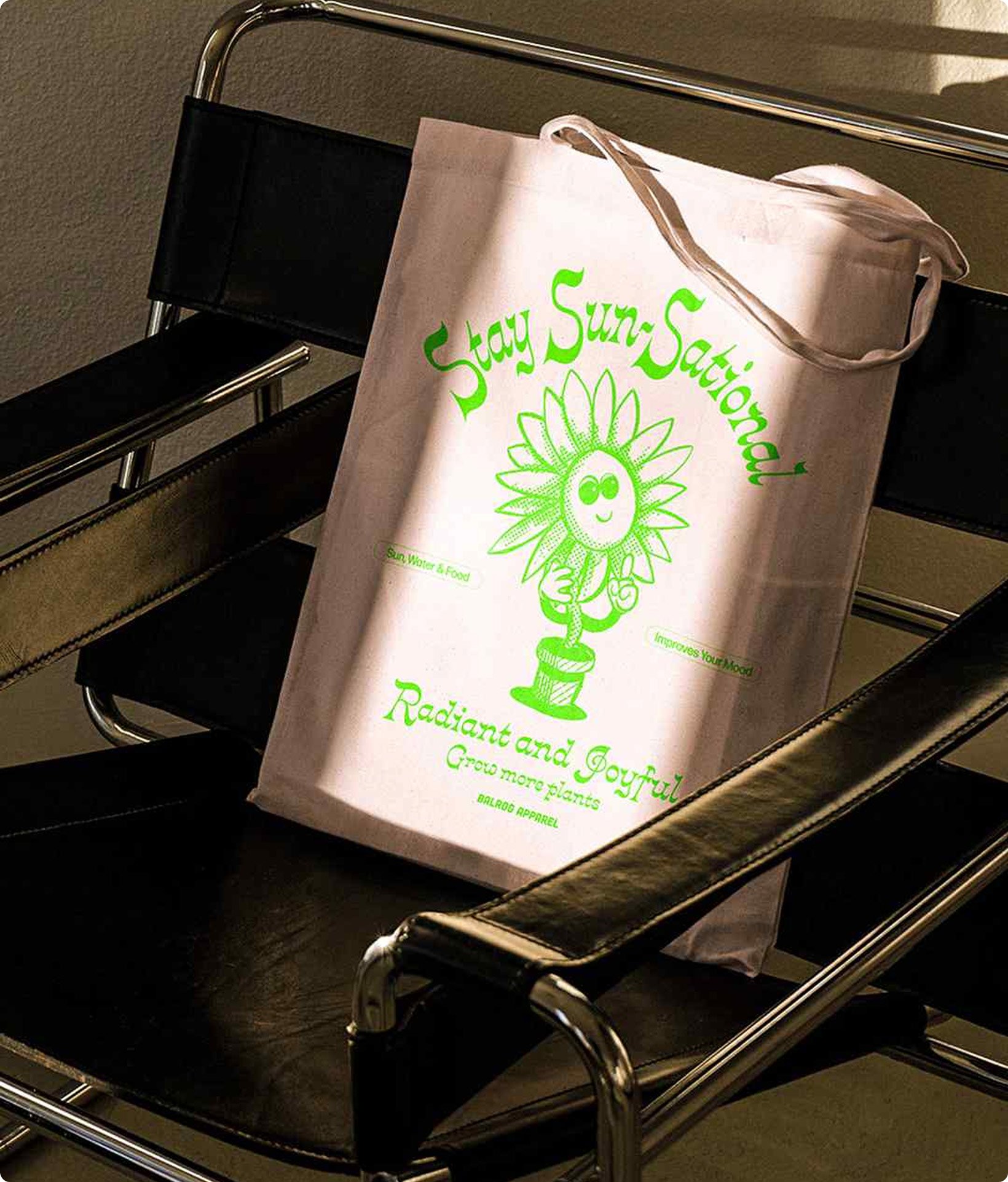 Tote bag with flower pot design on a black leather chair