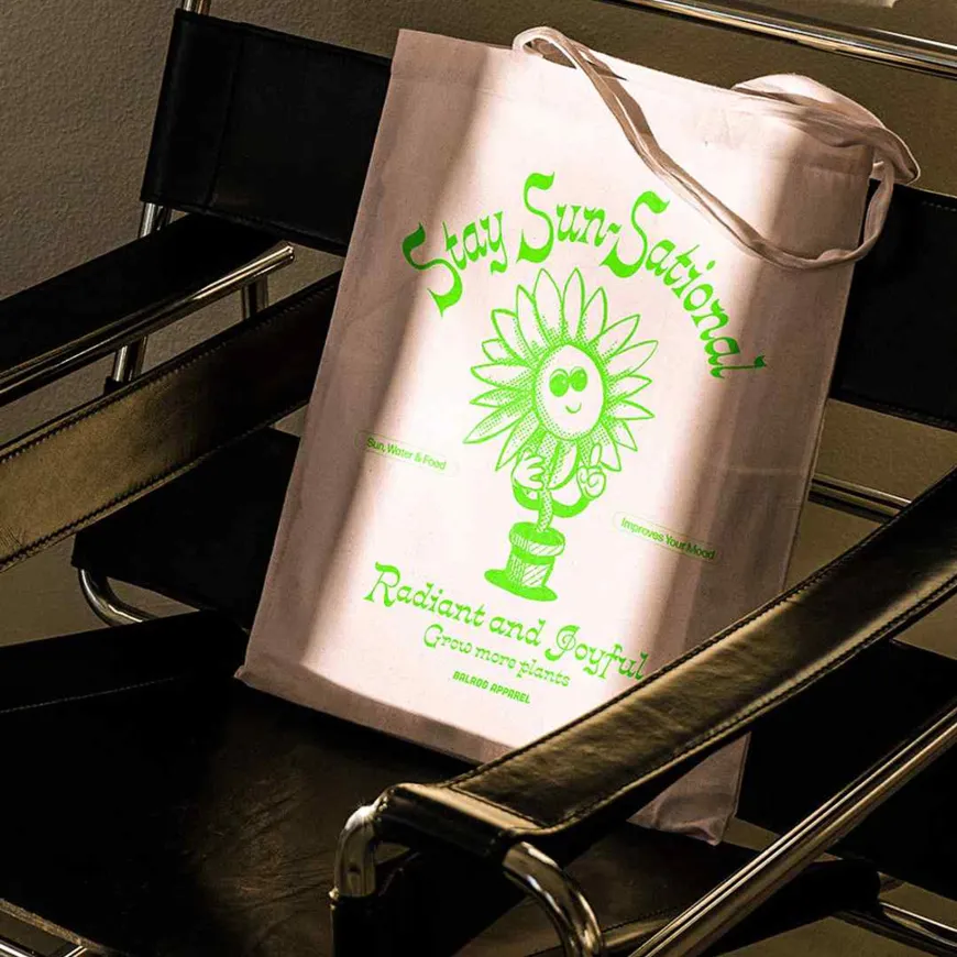 Tote bag with flower pot design on a black leather chair
