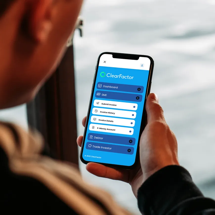 a mobile phone being held with a blue and white webpage on