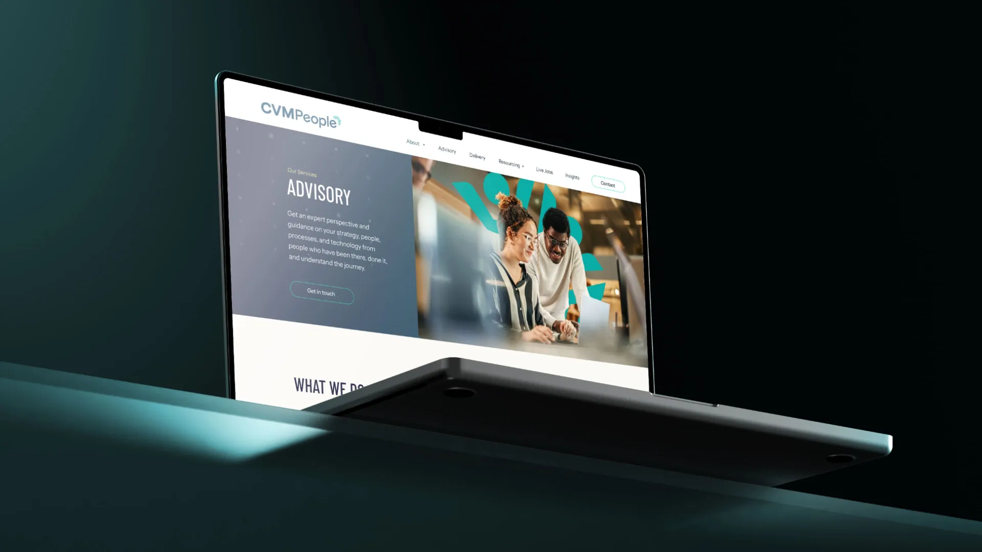 a laptop on a green table with the CVM people website on display