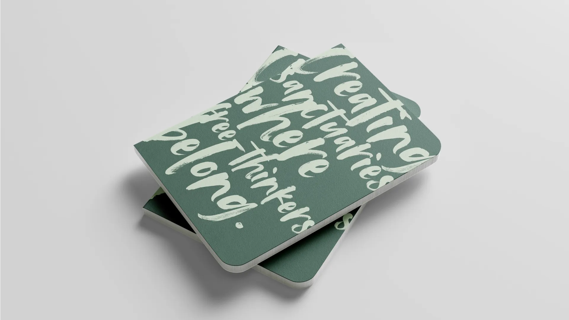 Green notepad with sage green writing on the cover.