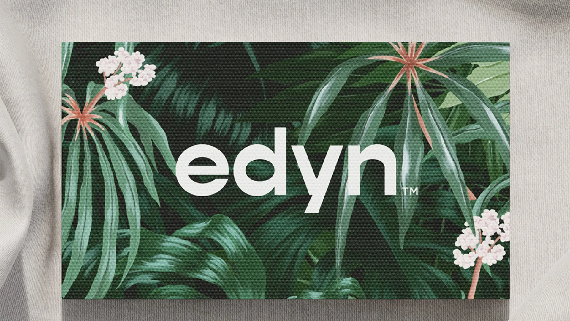 Tropical Edyn business card on a linen fabric background.