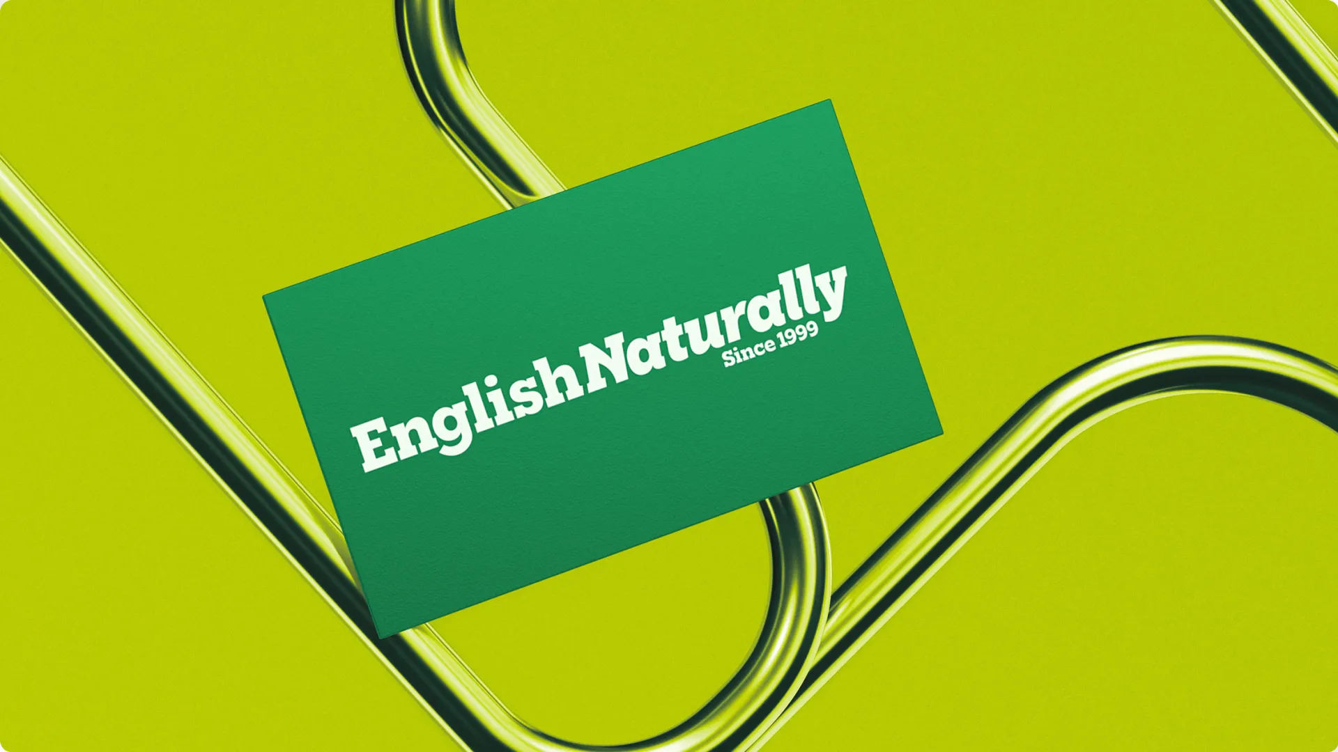 English Naturally business card displayed on a vivid green background with curved metallic elements