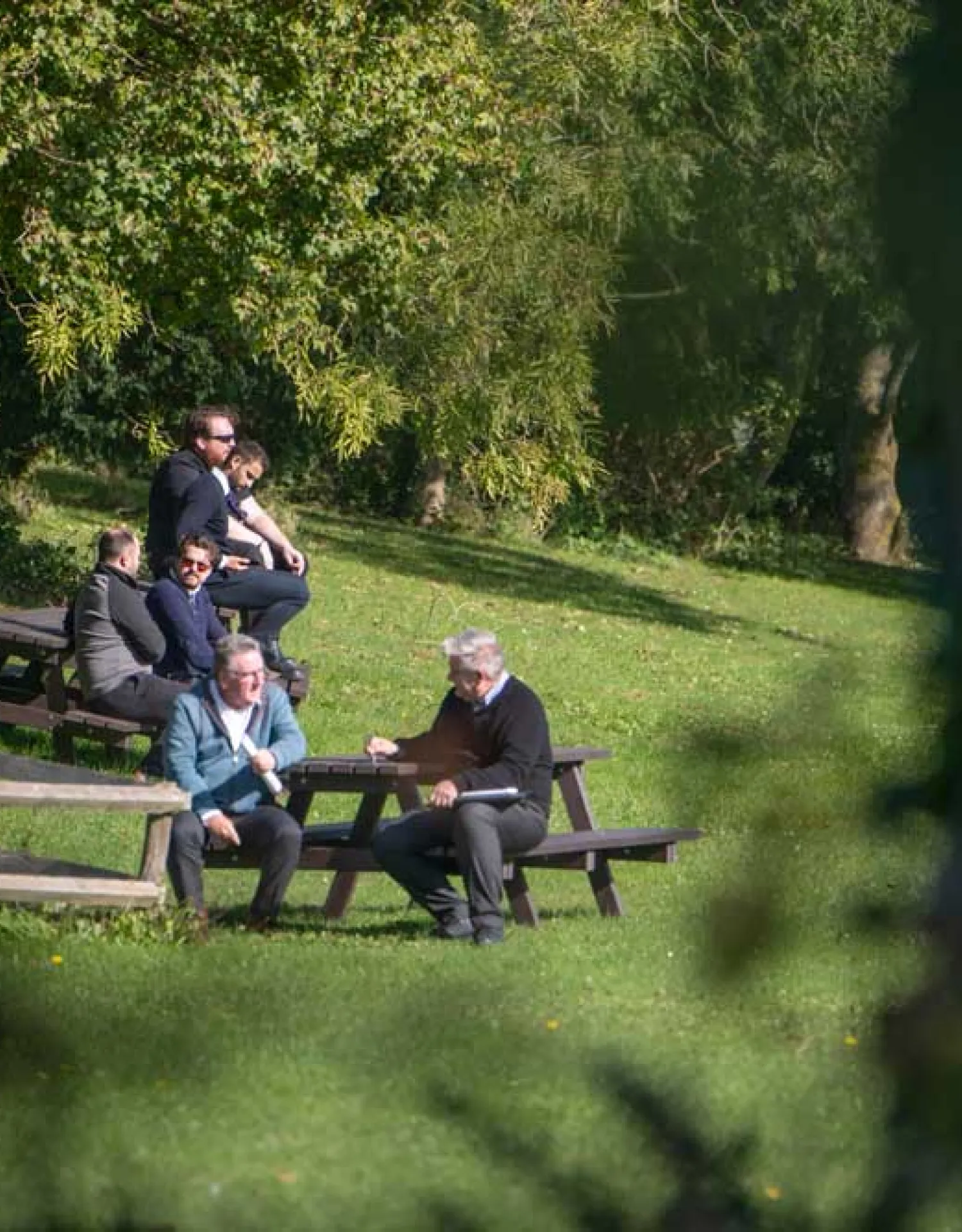 People sat at a picnic bench in Hazeley park