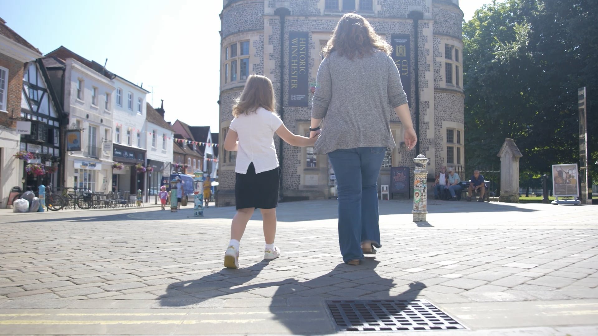 A mother and daughter walking towards and old building which is now a museum
