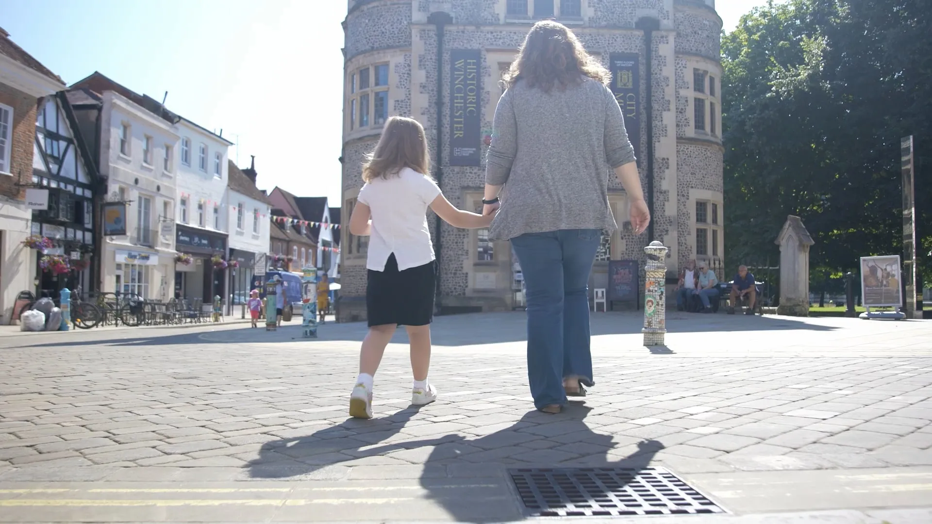 A mother and daughter walking towards and old building which is now a museum