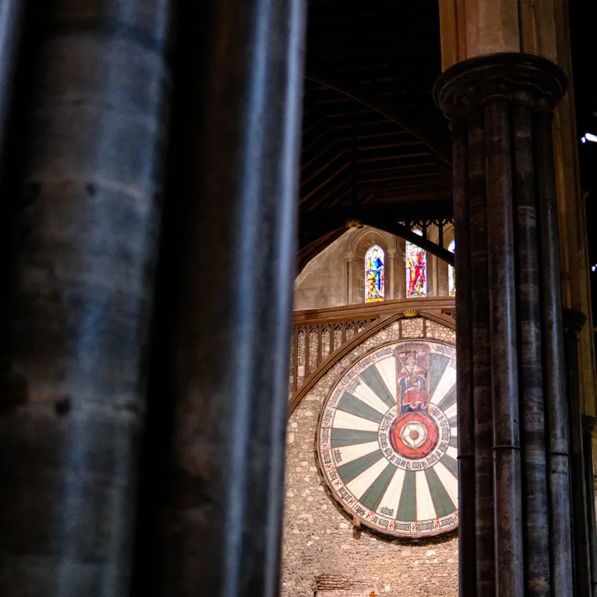 a view between pillars of the round table on a wall