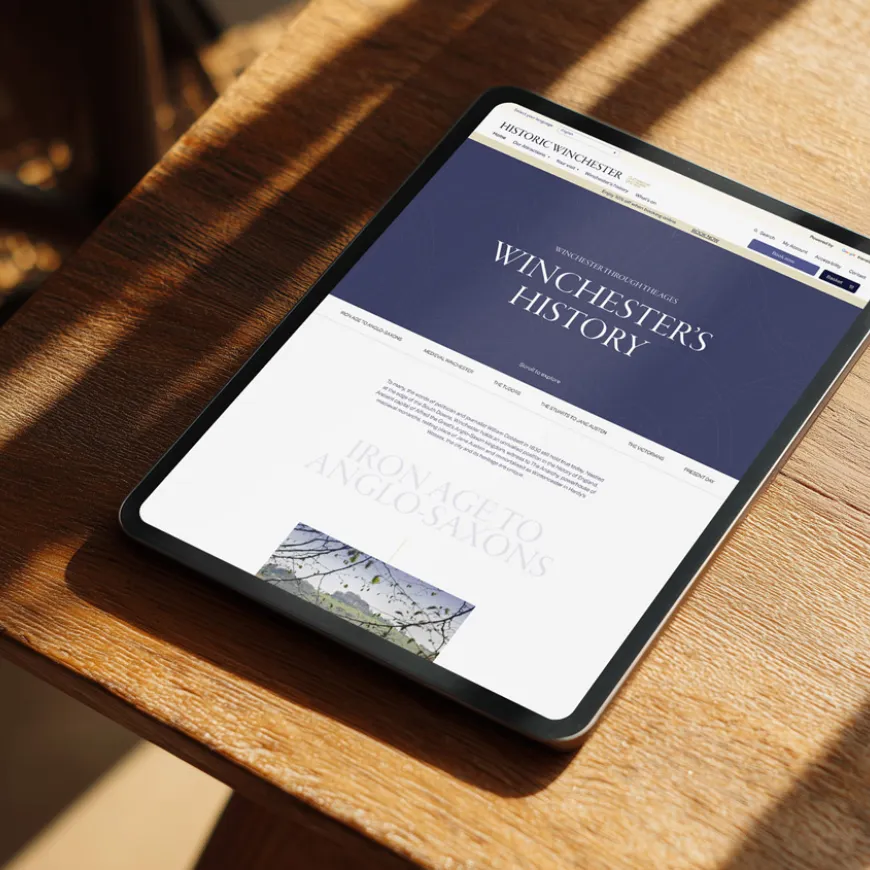 a mock up of a computer tablet on a desk showing the historic winchester website