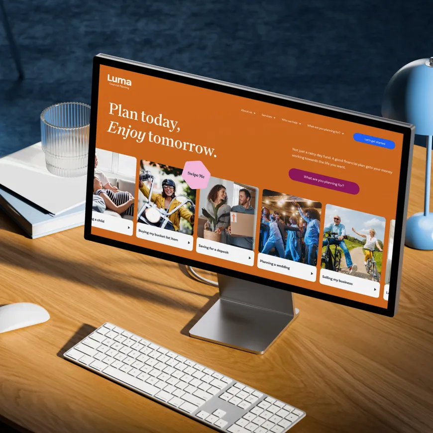 Desktop computer displaying the Luma Financial Planning website on a modern wooden desk