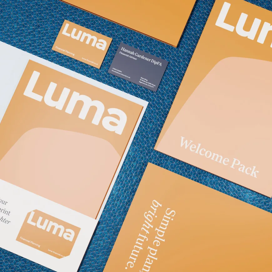 Flat lay of Luma Financial Planning stationery and welcome pack materials arranged on a patterned surface