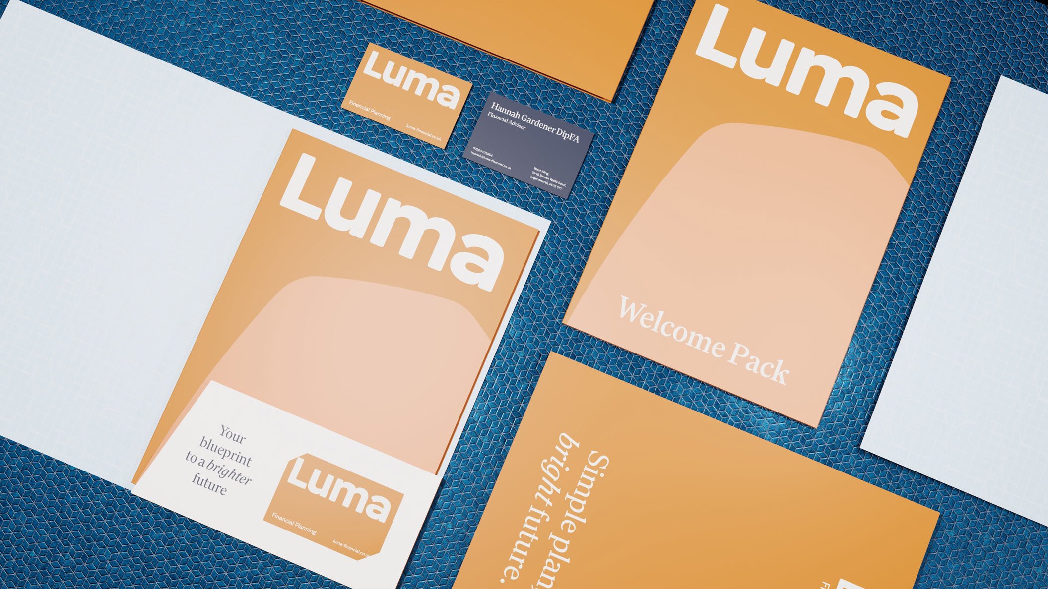 Flat lay of Luma Financial Planning stationery and welcome pack materials arranged on a patterned surface