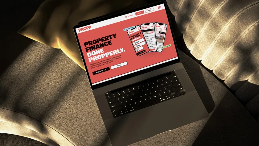 Laptop mockup of Propp home page on sofa.