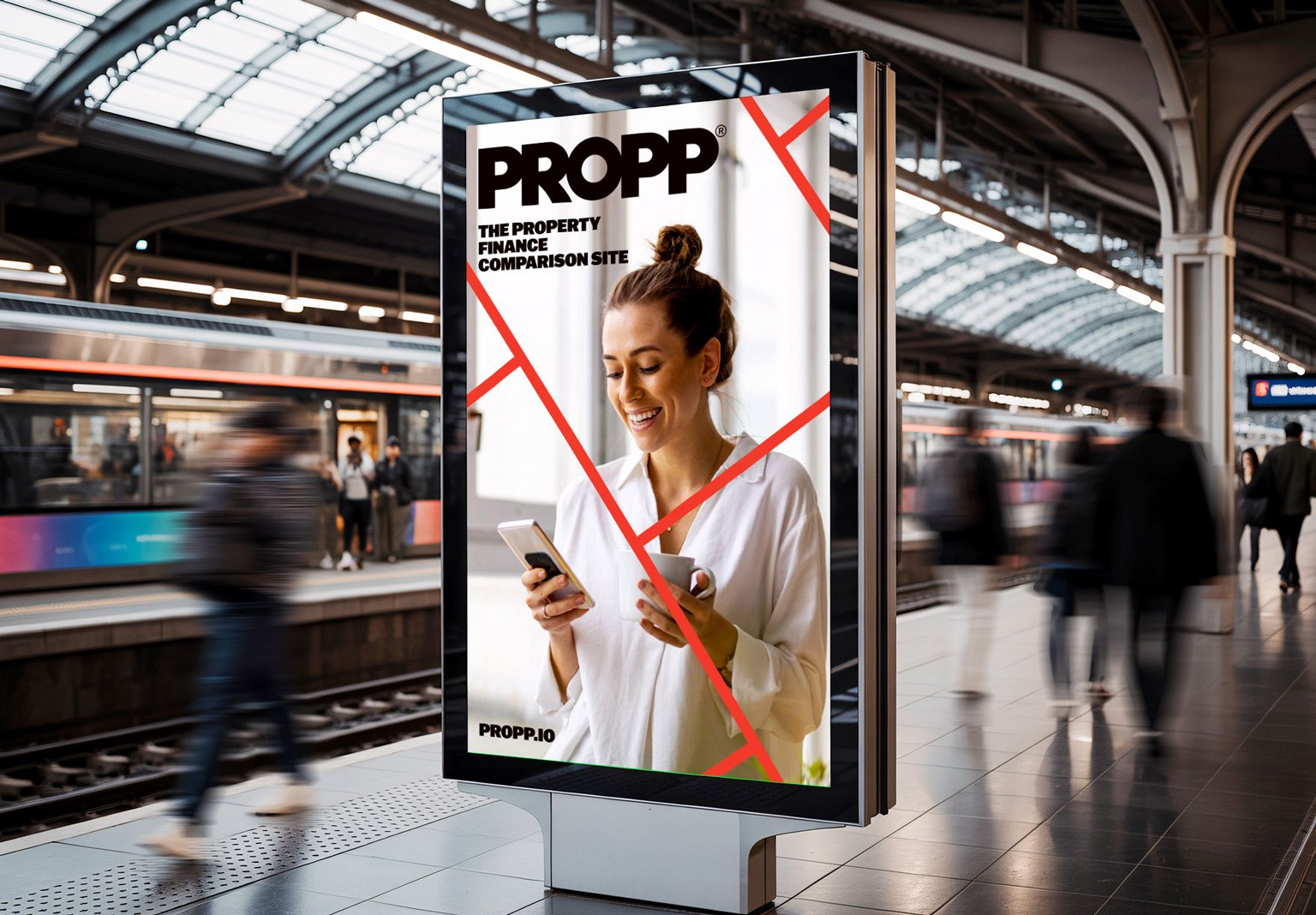 Busy trainstation with display screen showing Propp advertisement