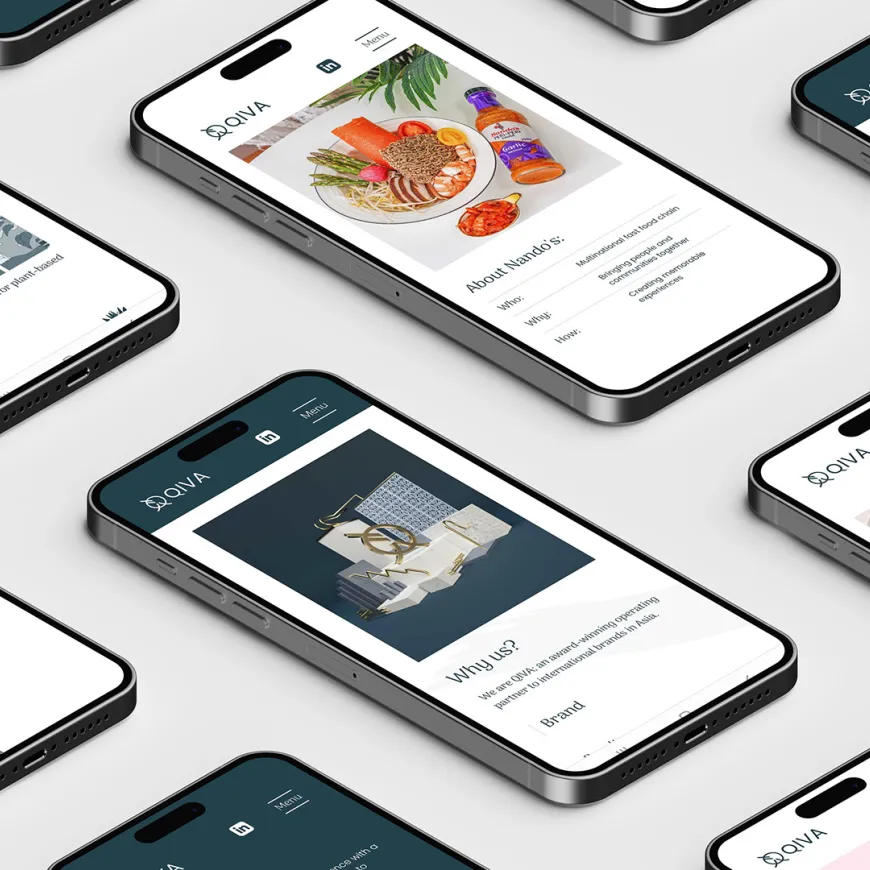 multiple mobile phones lay on a grey table displaying aspects of a website