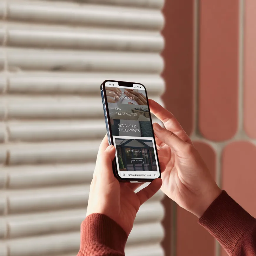 Person holding mobile phone with two hands