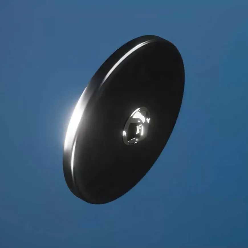 a dark circular object in the middle of a blue background