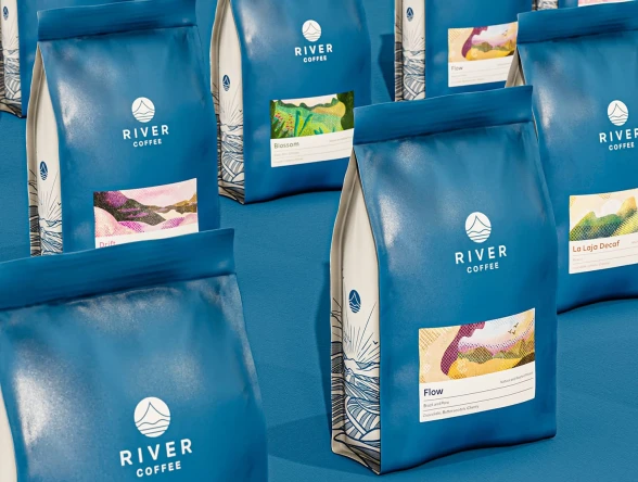 Multiple coffee bags in a deep blue, each featuring an illustration