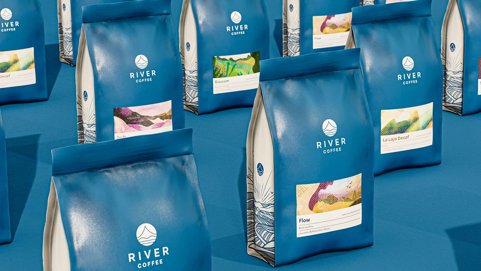 Multiple coffee bags in a deep blue, each featuring an illustration