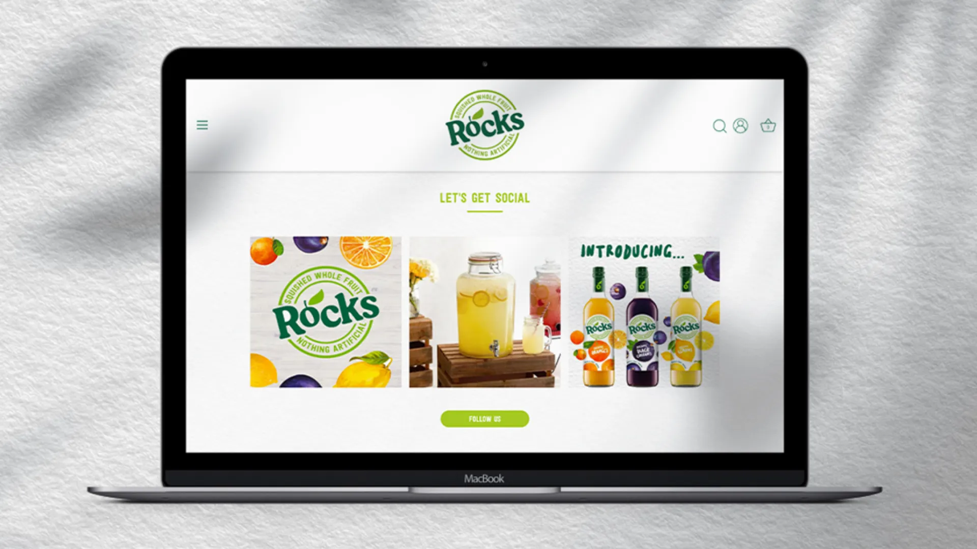 a macbook on a white background with the rocks drinks homepage