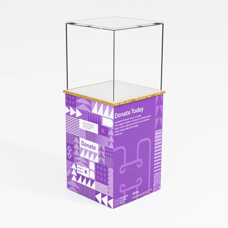 a tall purple pillar with the arc branding, on top is a clear glass cube