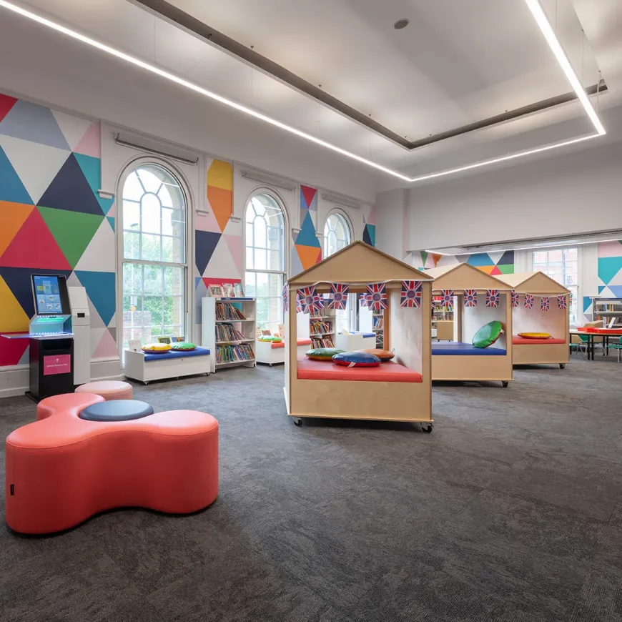 Three wooden structures on the floor of a childrens library