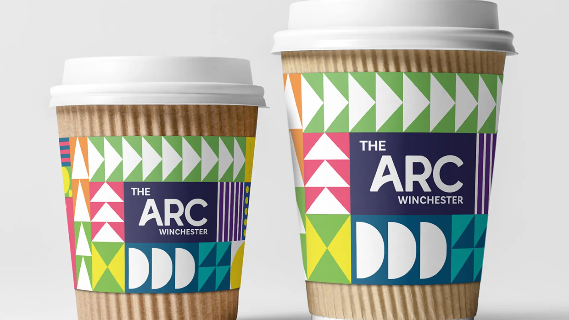 Two coffee cups featuring 'The Arc' Branding
