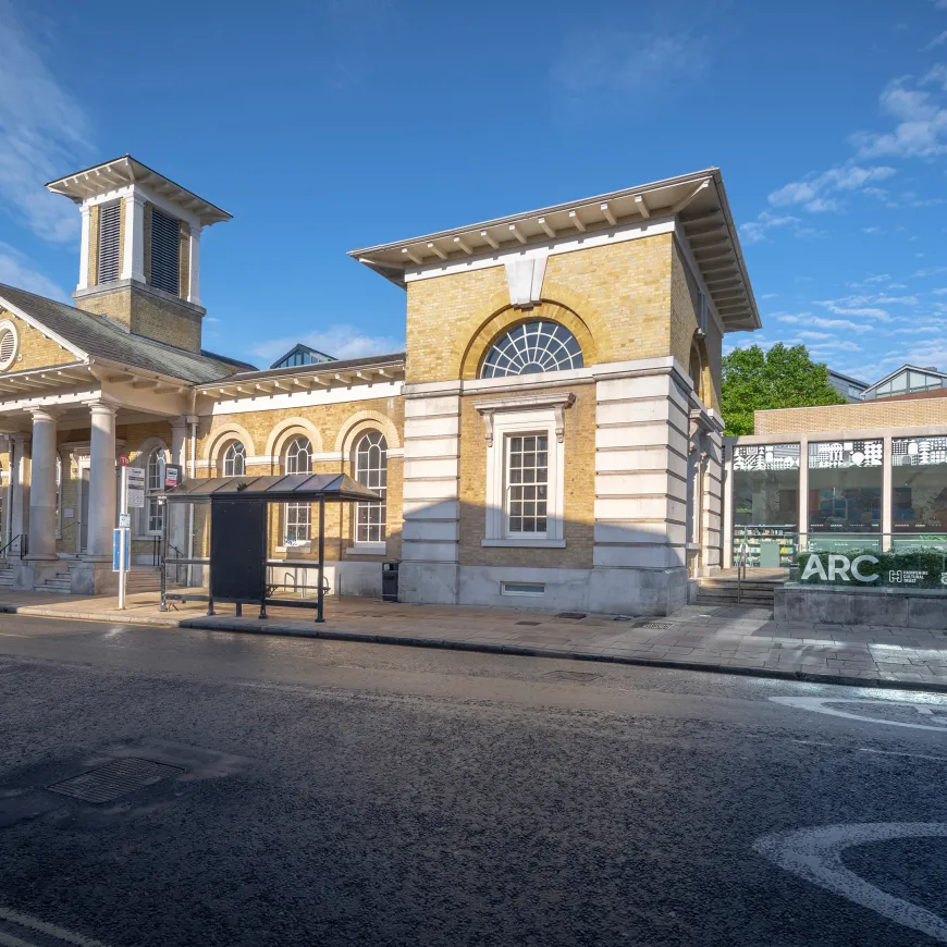 Exterior image of a stone building with 'The Arc' branding on the outside