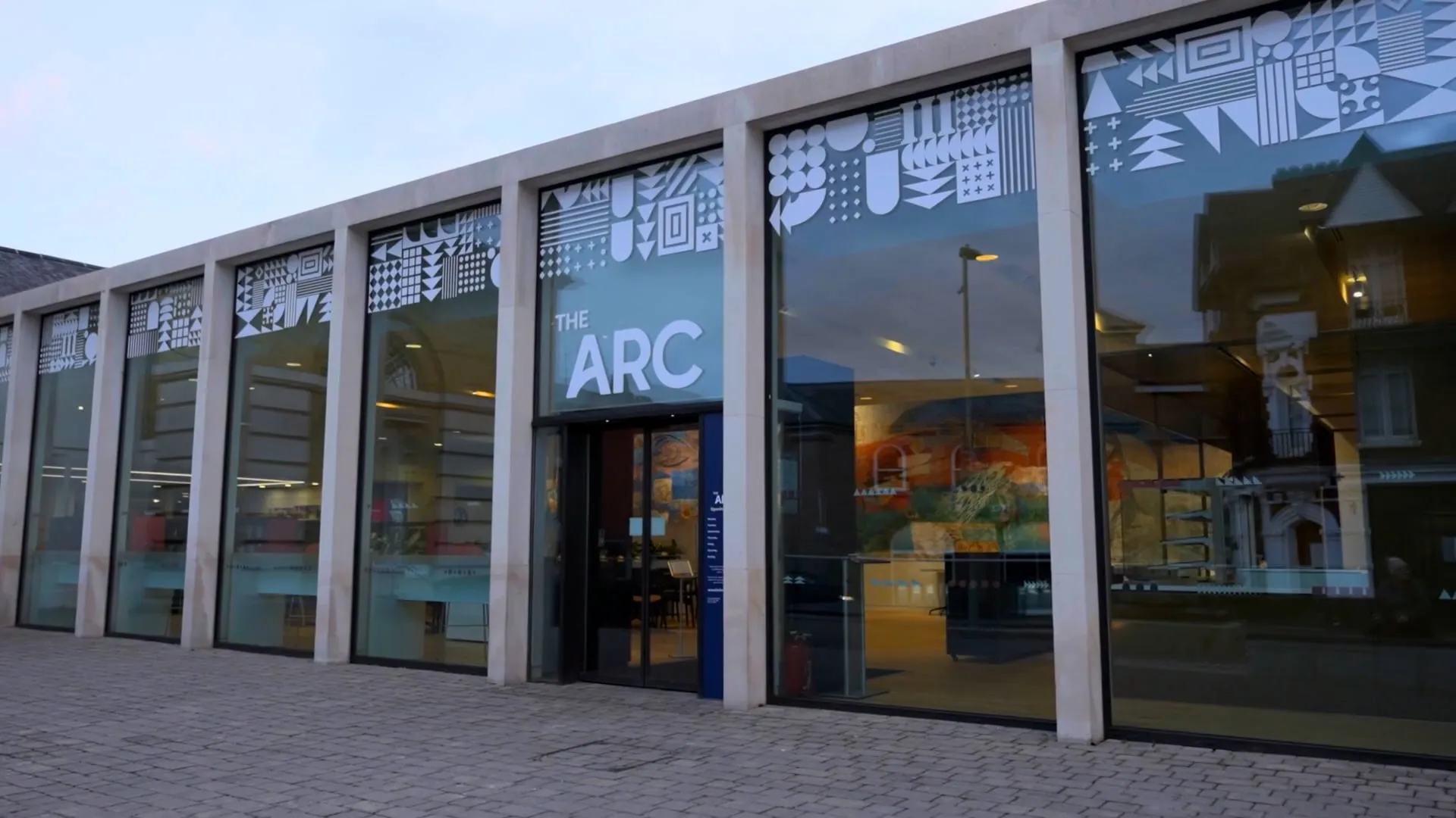 Exterior of the Arc featuring glass frontage and white branding