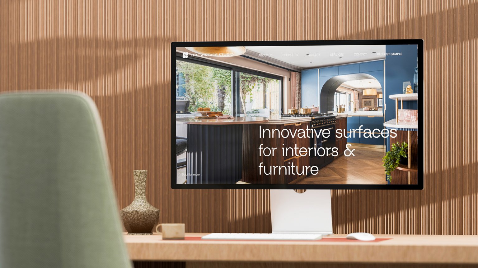 Computer displaying an interior design website on a modern desk