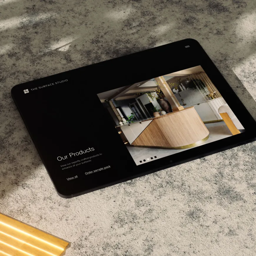 Tablet displaying an interior design website on a stone surface