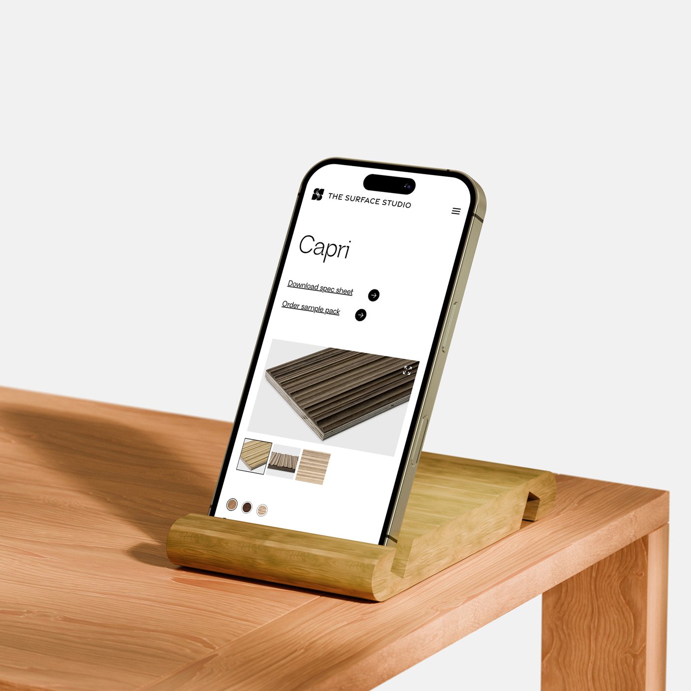 Smartphone displaying a product page in a wooden stand