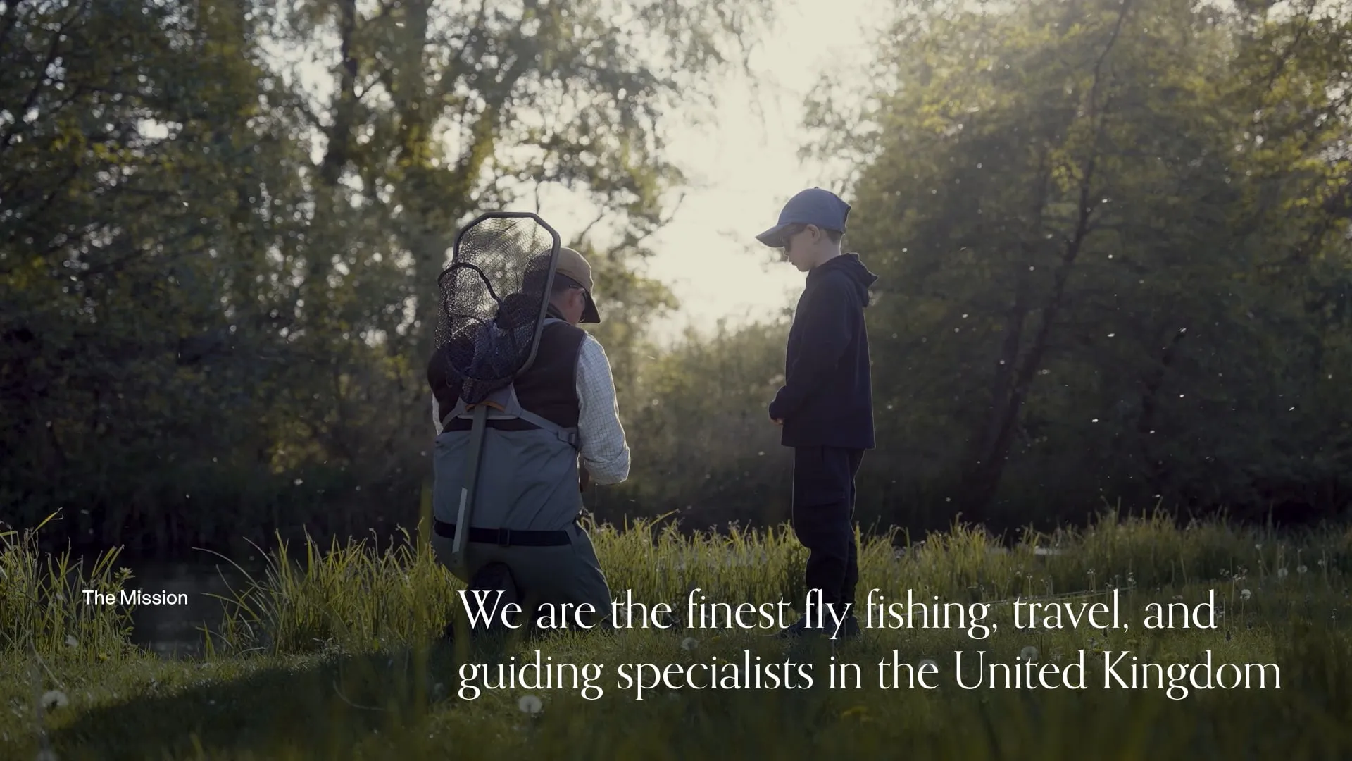 Photo of a man in fishing gear crouched down next to a small child outside, with text overlay.
