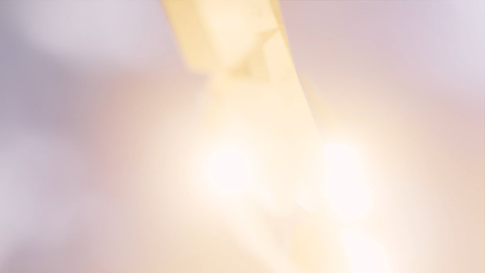 Blurred light in sky, with pink soft hues of light.