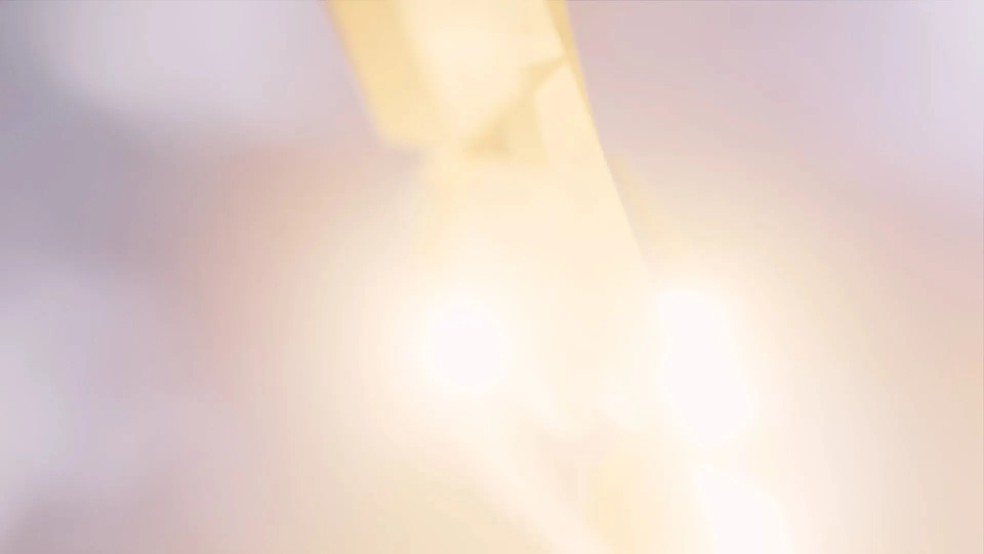 Blurred light in sky, with pink soft hues of light.