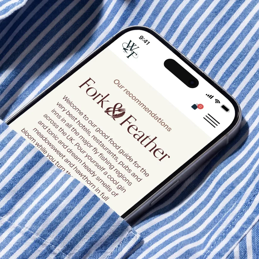 Mobile phone poking out of a blue and white striped shirt pocket.