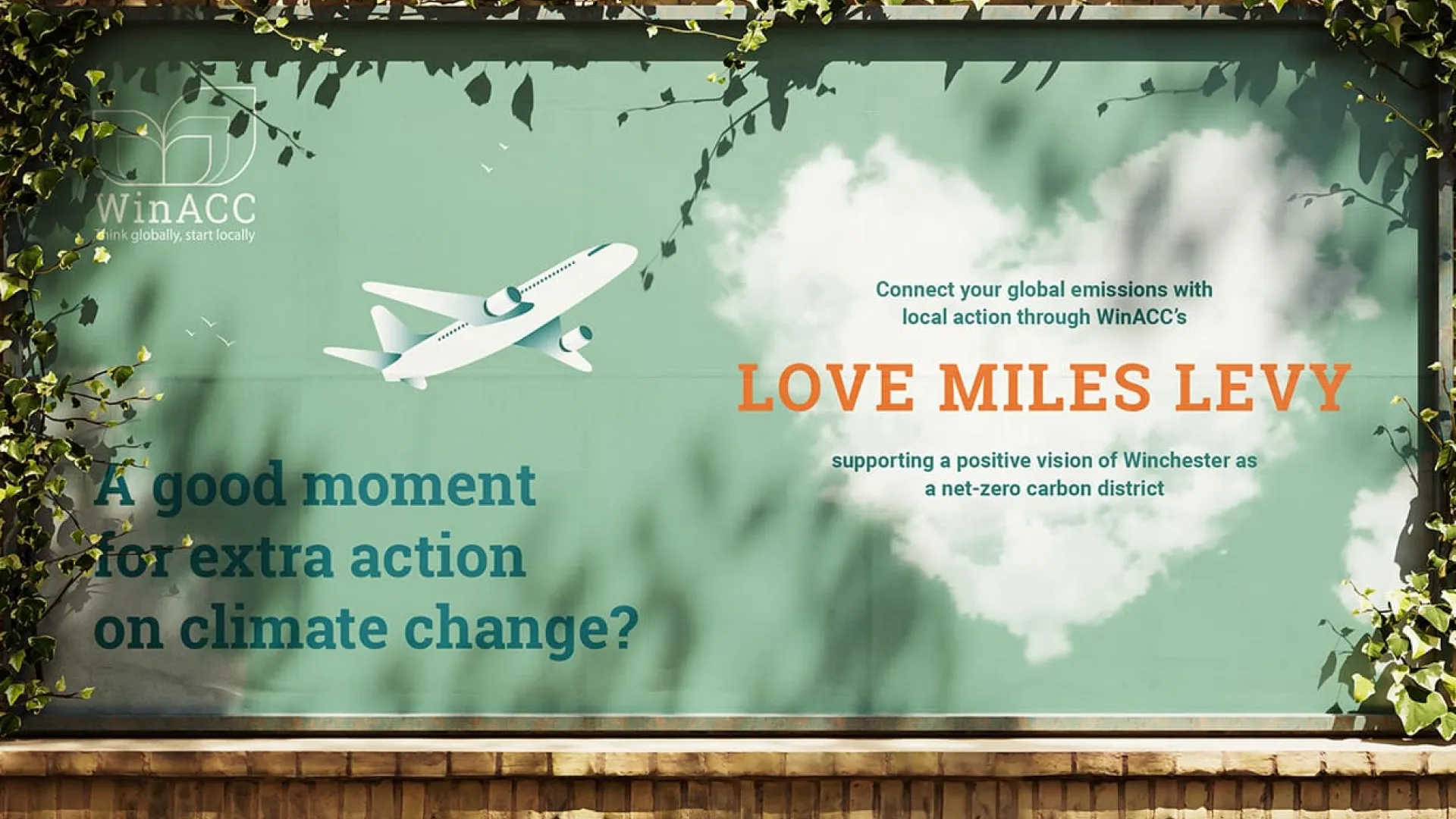 Green billboard with a plane and 'Love miles levy' in orange