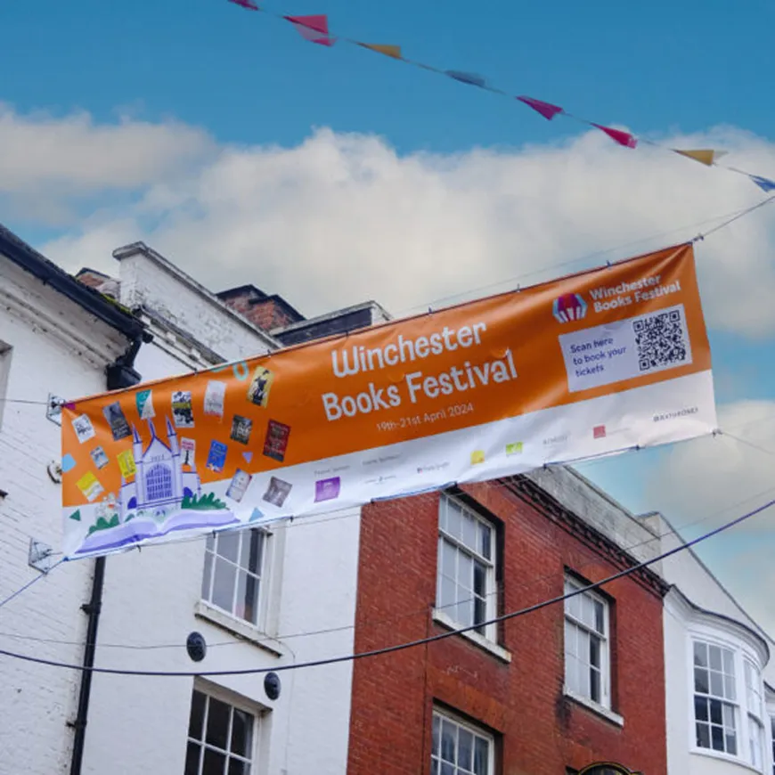 Picture of Winchester books festival banner hung across Winchester high street